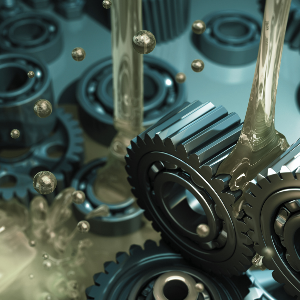 Close-up of industrial gears, bearings and lubrication oil illustrating the chemicals and lubricants sector supporting manufacturing and engineering supply chains.